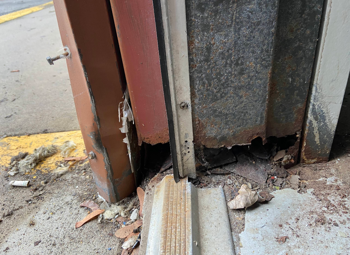 badly damaged door frame and threshold
