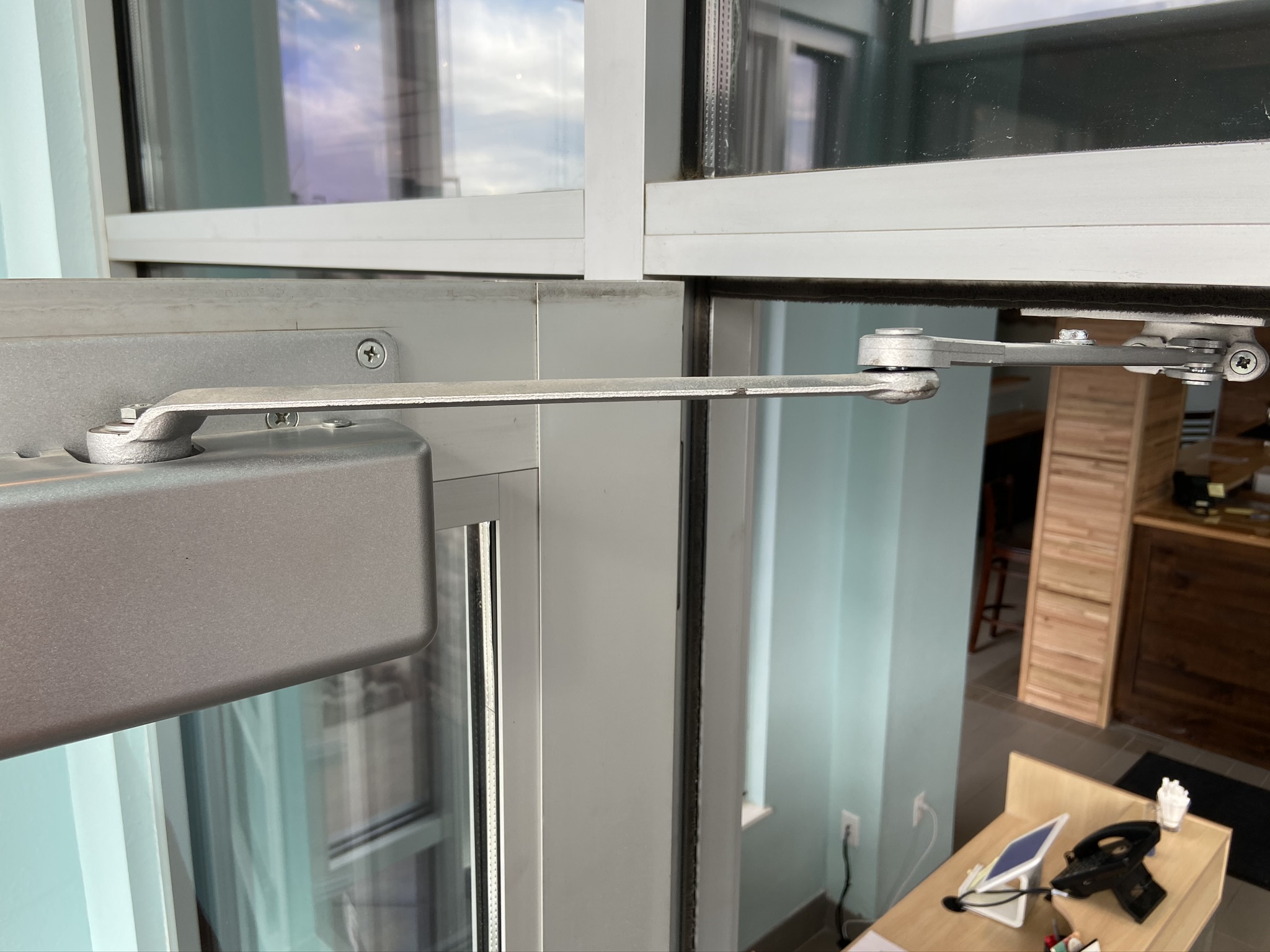 A door closer installed on a door at a commercial property.